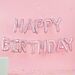 Vaaleanpunainen "Happy Birthday"-muotoinen foliopallo.